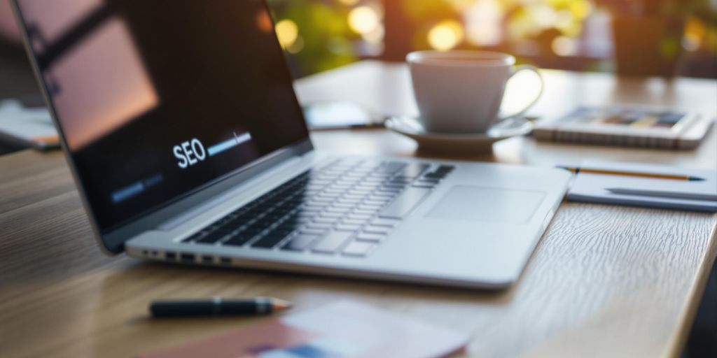 A modern digital workspace with a laptop and coffee.